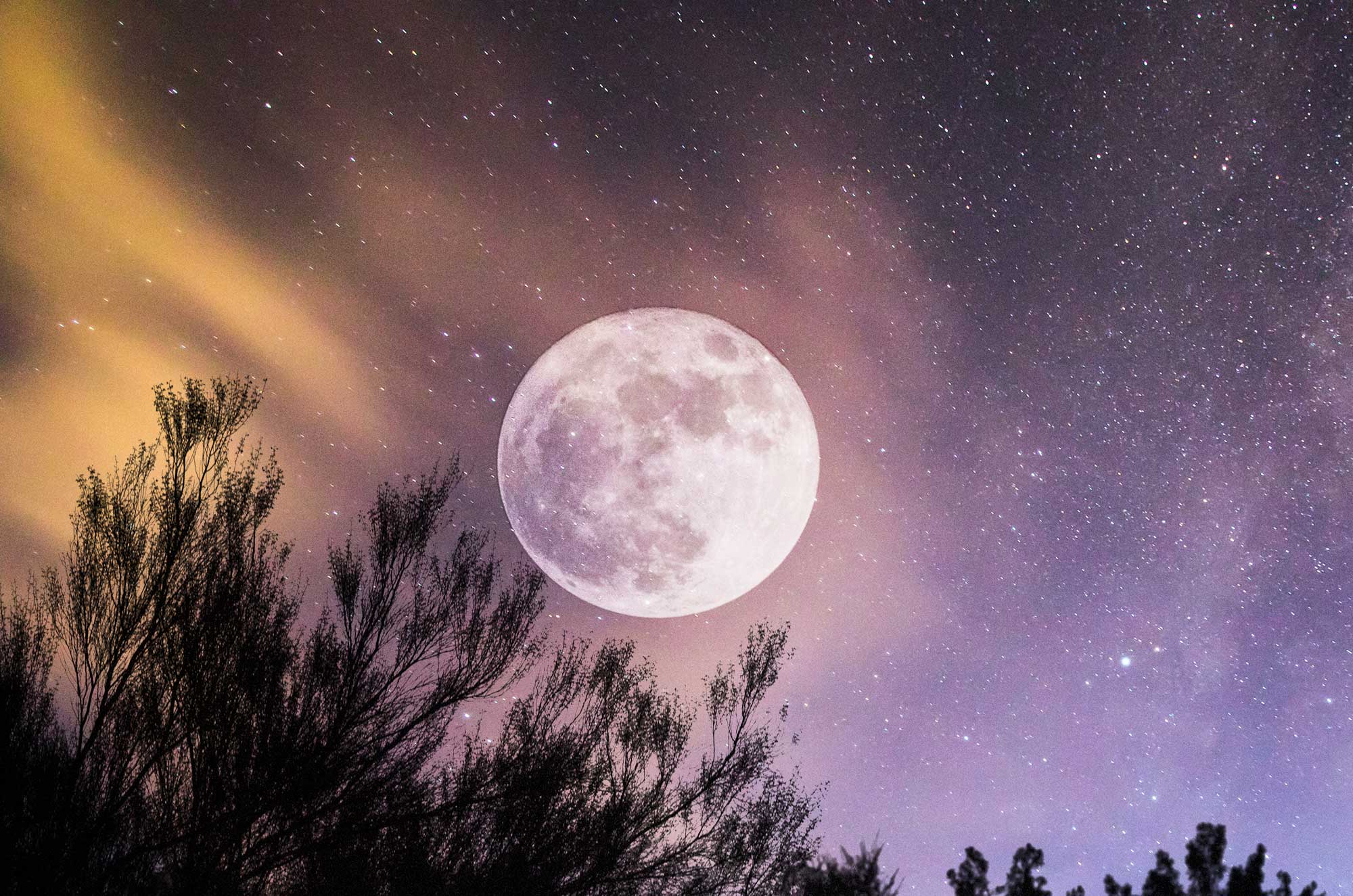 A full moon with the stars in the background.